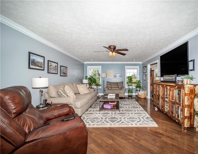 living room with crown molding, ceiling fan, wood finished floors, and baseboards