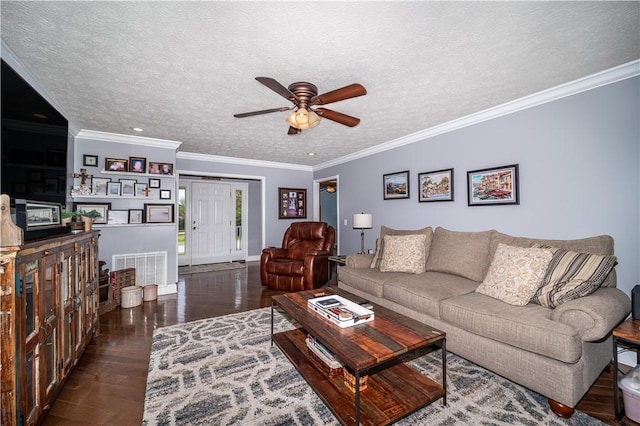 living area featuring a textured ceiling, visible vents, hardwood / wood-style floors, ornamental molding, and a ceiling fan