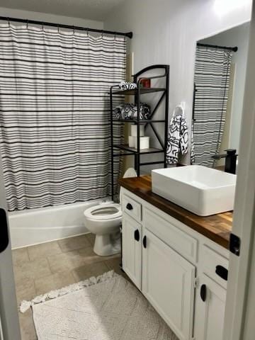 full bathroom featuring toilet, vanity, and shower / bath combination with curtain
