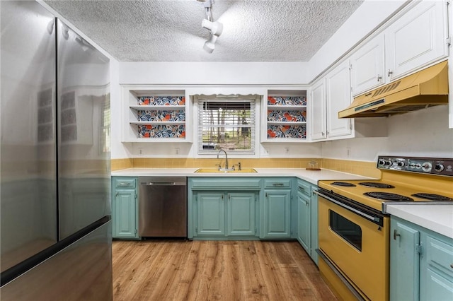 kitchen with a sink, stainless steel appliances, under cabinet range hood, open shelves, and a textured ceiling