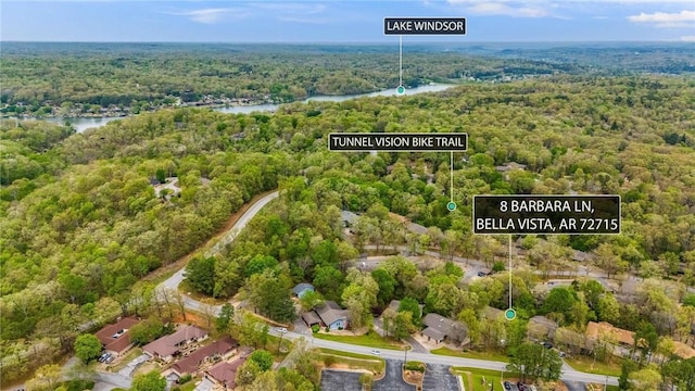 bird's eye view with a water view and a forest view