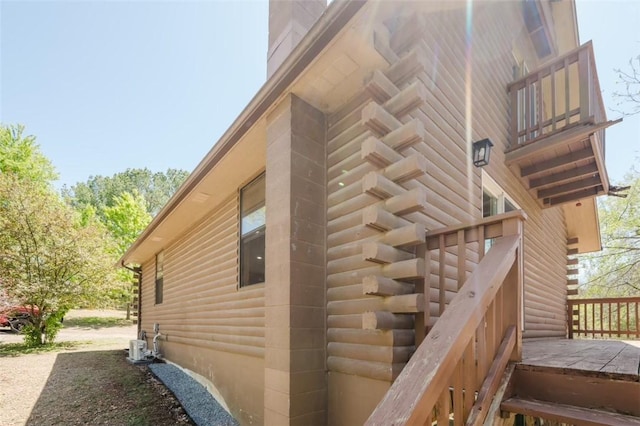1010 Ashley Ln, Pea Ridge, AR 72751 - view of property exterior with log siding, a chimney, and a balcony