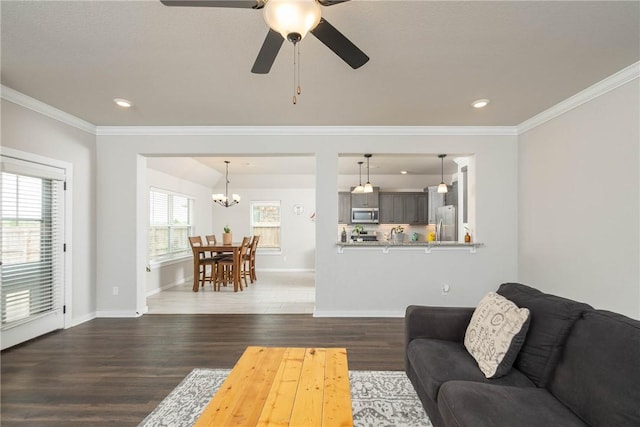 living room featuring crown molding, recessed lighting, ceiling fan with notable chandelier, and dark wood-type flooring