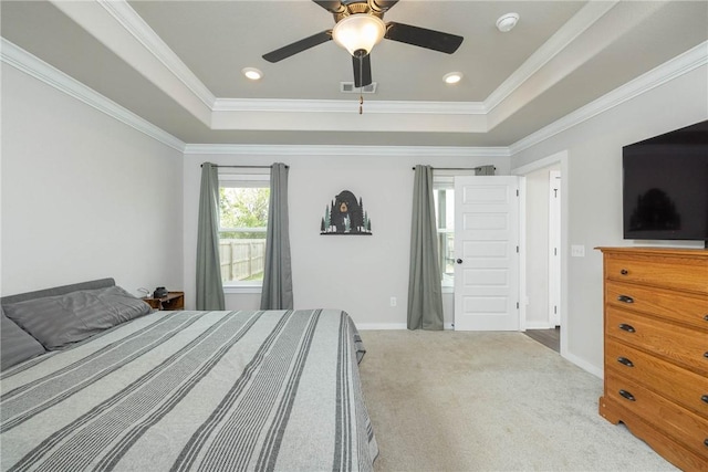 bedroom with visible vents, ornamental molding, carpet, and a tray ceiling