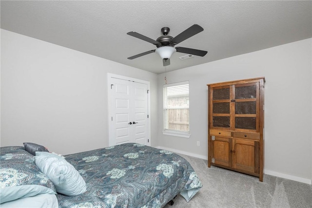bedroom with visible vents, ceiling fan, baseboards, and light carpet