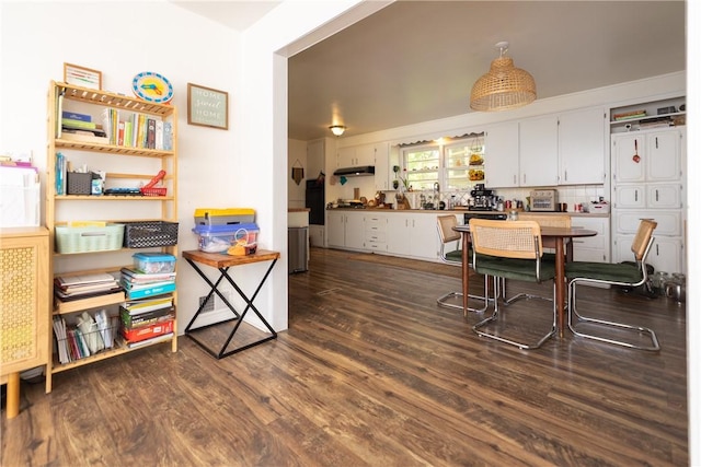 dining space with dark wood-type flooring