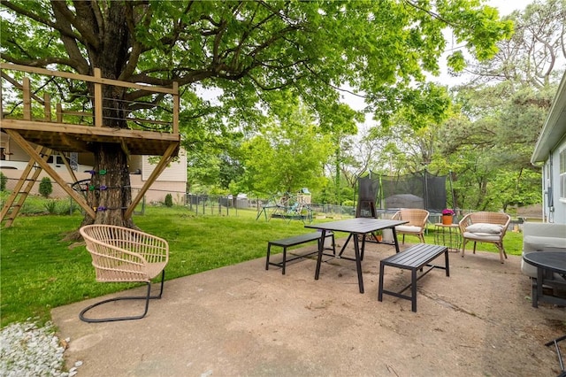 view of community with a trampoline, a fenced backyard, a playground, a yard, and a patio