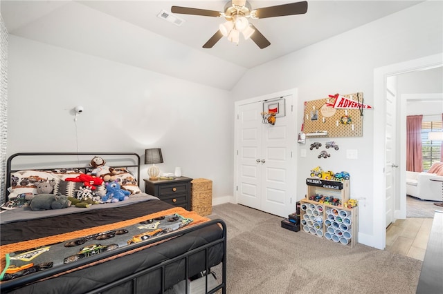 carpeted bedroom featuring baseboards, a ceiling fan, lofted ceiling, and visible vents