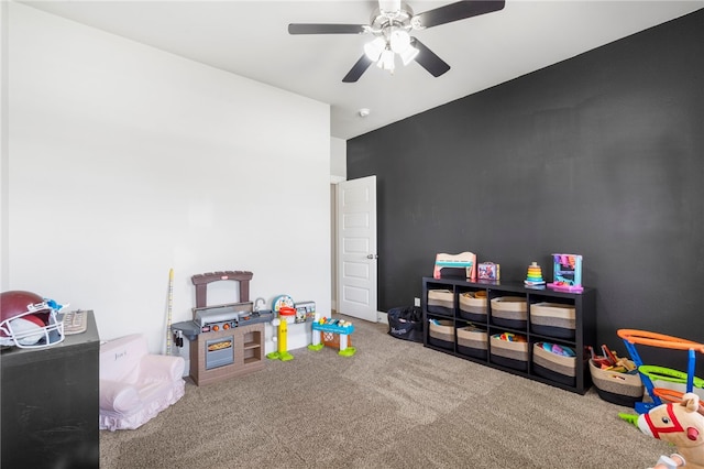 recreation room with carpet floors and a ceiling fan