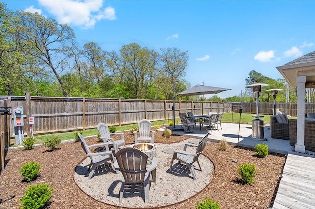 view of yard with a fenced backyard, a patio, and a fire pit