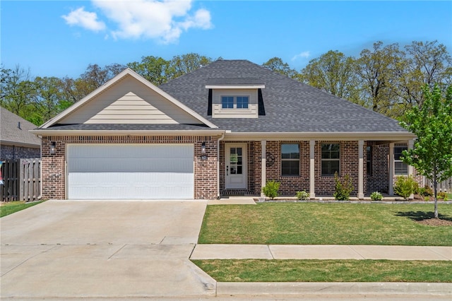 view of front of property featuring a garage, a front yard, brick siding, a shingled roof, and concrete driveway