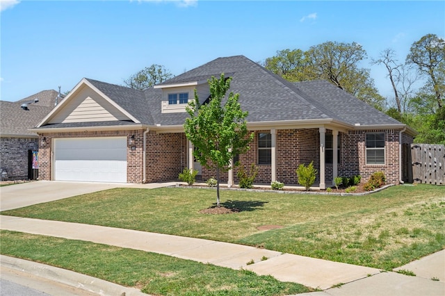 traditional home featuring a front yard, a garage, brick siding, fence, and concrete driveway