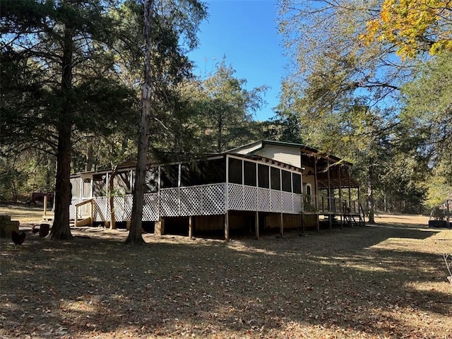 2525 Dustin Ln, Omaha, AR 72662 - rear view of property featuring a wooden deck and a sunroom
