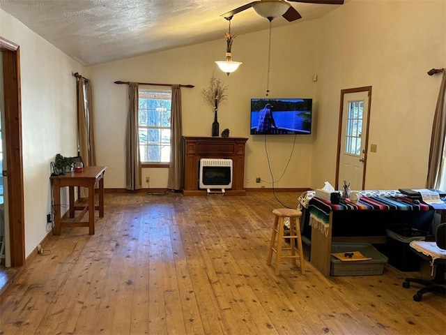 2525 Dustin Ln, Omaha, AR 72662 - living area with wood-type flooring, heating unit, baseboards, ceiling fan, and vaulted ceiling