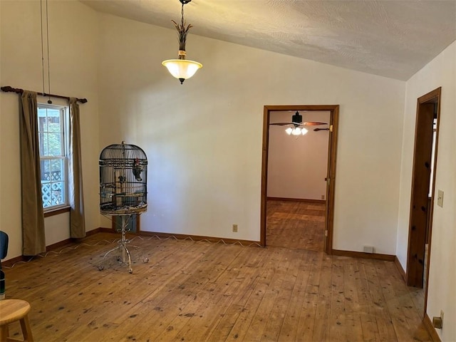 2525 Dustin Ln, Omaha, AR 72662 - dining space with wood-type flooring, a ceiling fan, baseboards, and lofted ceiling