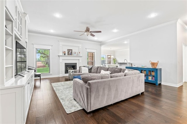 living room with a fireplace, a ceiling fan, recessed lighting, and dark wood-type flooring