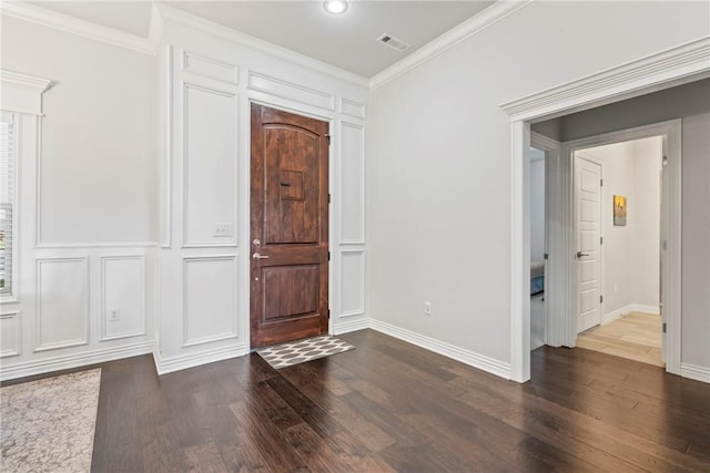 foyer entrance with visible vents, dark wood finished floors, crown molding, and baseboards