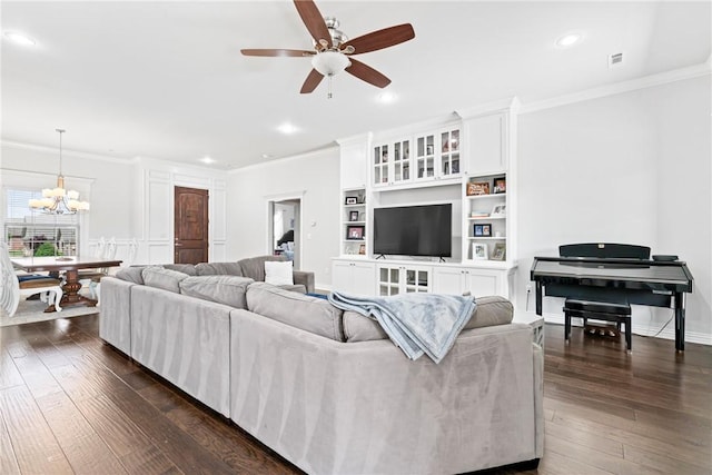 living room featuring ornamental molding, ceiling fan with notable chandelier, and dark wood-style floors