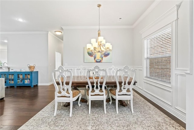 dining room featuring crown molding, dark wood-style flooring, and a chandelier