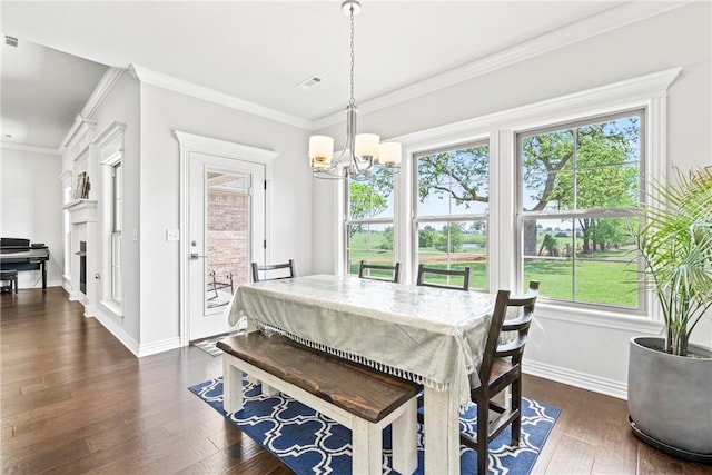 dining space featuring dark wood-style flooring, a notable chandelier, and plenty of natural light