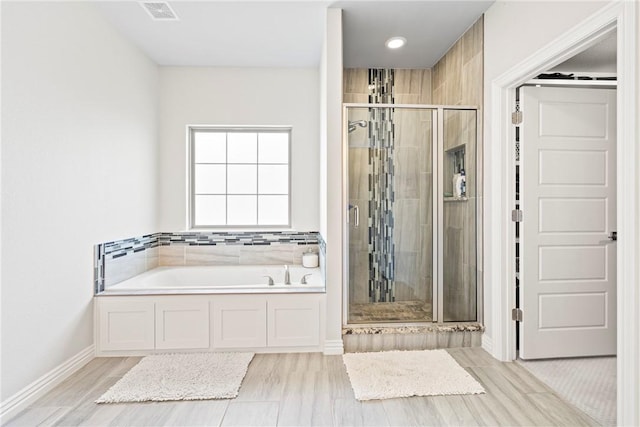 bathroom featuring visible vents, a garden tub, baseboards, recessed lighting, and a stall shower