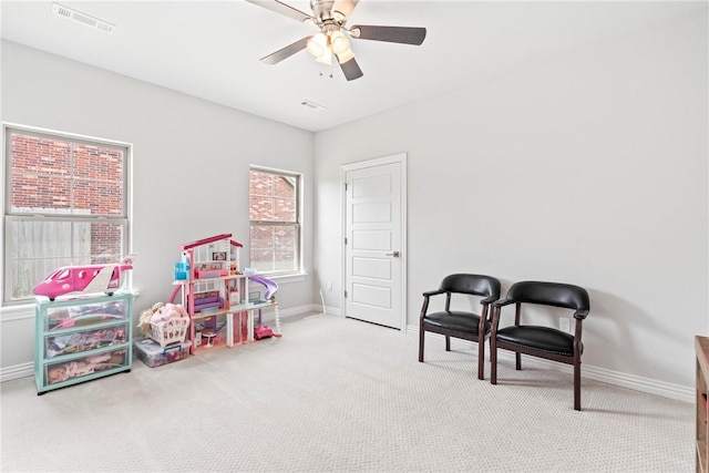 rec room with visible vents, baseboards, carpet floors, and ceiling fan