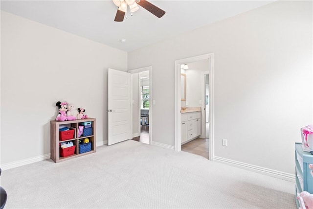 playroom featuring baseboards, a ceiling fan, and light colored carpet