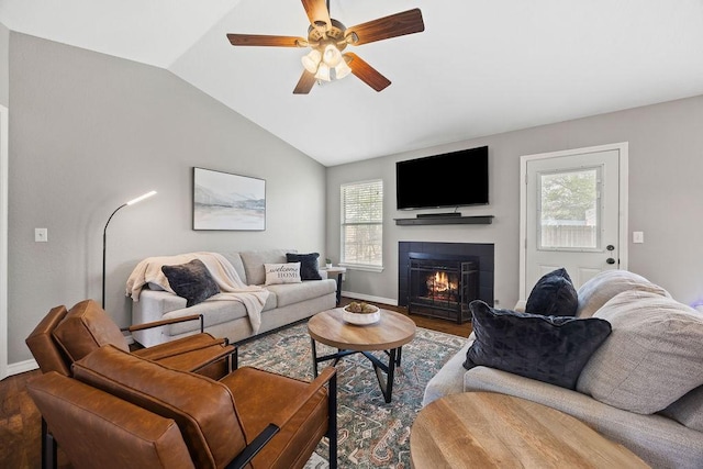 living area with baseboards, a ceiling fan, and wood finished floors