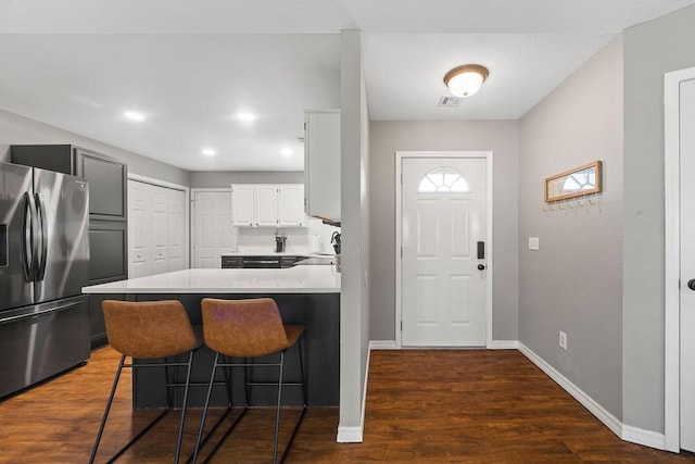 entryway featuring visible vents, recessed lighting, baseboards, and dark wood-type flooring