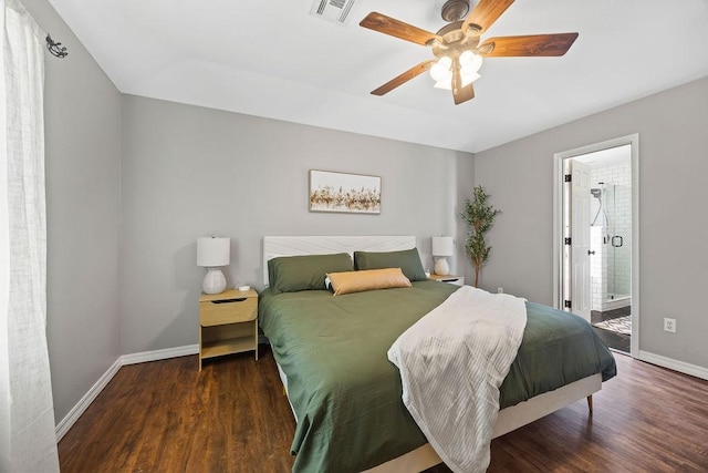 bedroom with ceiling fan, visible vents, wood finished floors, baseboards, and ensuite bath