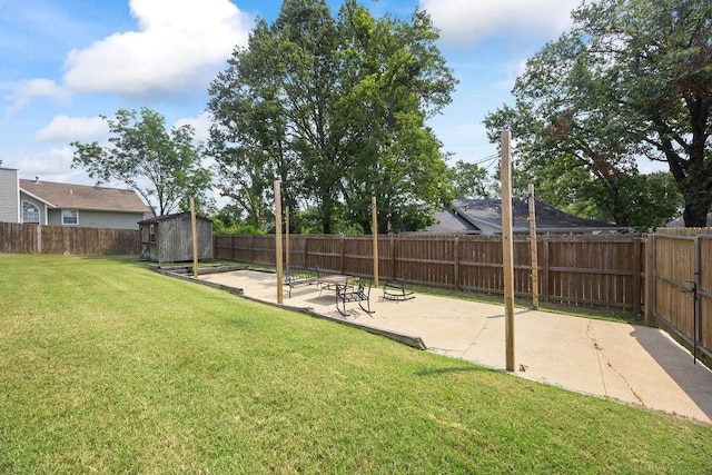 view of yard with a storage shed, a patio, an outbuilding, and a fenced backyard