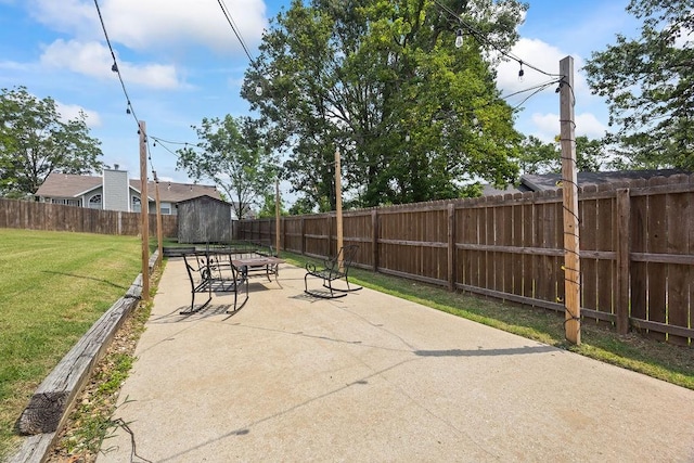 view of patio featuring a fenced backyard, an outbuilding, and a storage shed