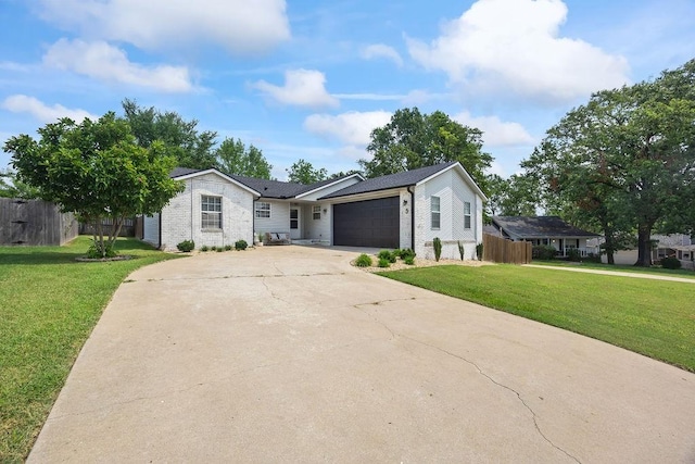 ranch-style house with fence, an attached garage, concrete driveway, and a front yard