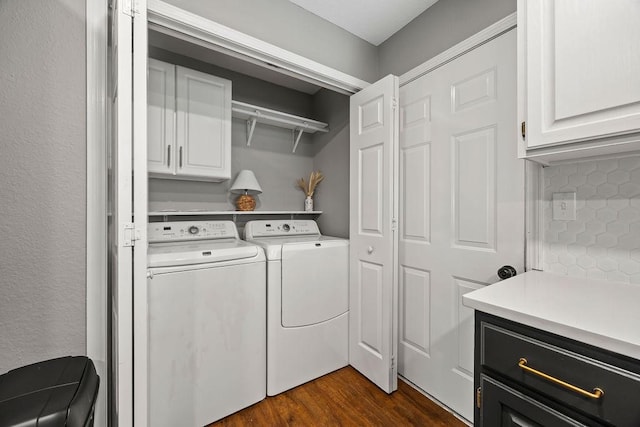 laundry area featuring cabinet space, washing machine and dryer, and dark wood finished floors
