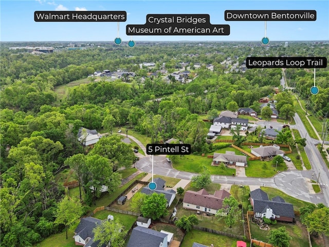 drone / aerial view featuring a forest view and a residential view