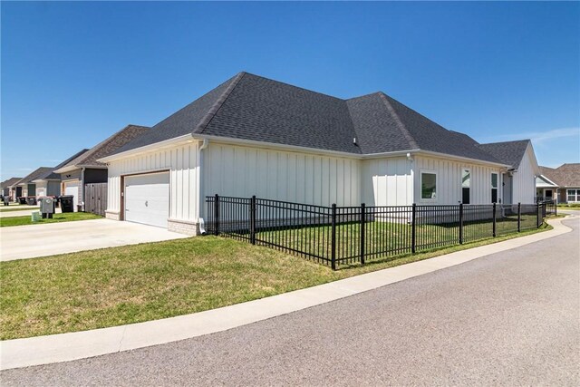 6761 Somerset Pl, Springdale, AR 72762 - view of side of home with a lawn, a garage, and board and batten siding