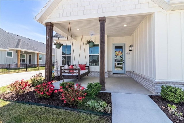 6761 Somerset Pl, Springdale, AR 72762 - entrance to property featuring covered porch, fence, and board and batten siding