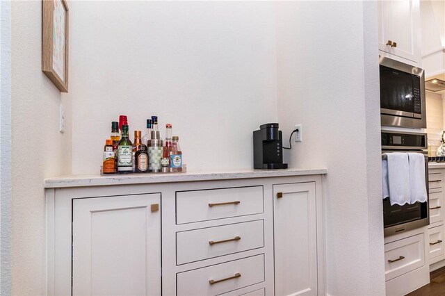 6761 Somerset Pl, Springdale, AR 72762 - bar featuring stainless steel appliances and a dry bar