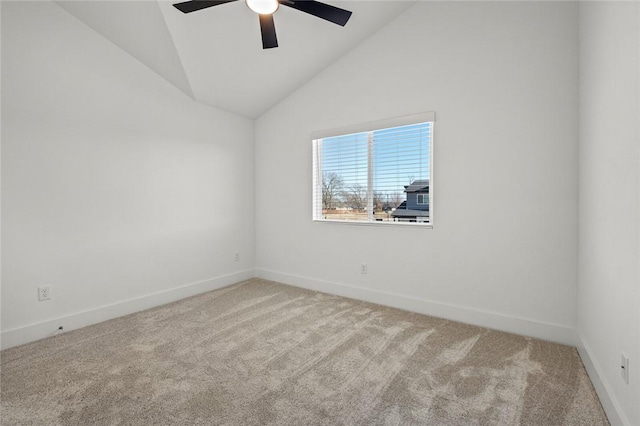 carpeted empty room featuring baseboards, ceiling fan, and vaulted ceiling
