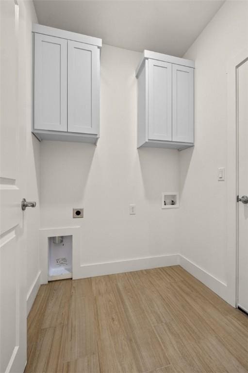 laundry area with washer hookup, electric dryer hookup, cabinet space, baseboards, and light wood-style flooring