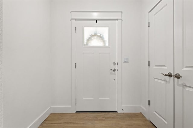 entryway featuring baseboards and light wood-style flooring