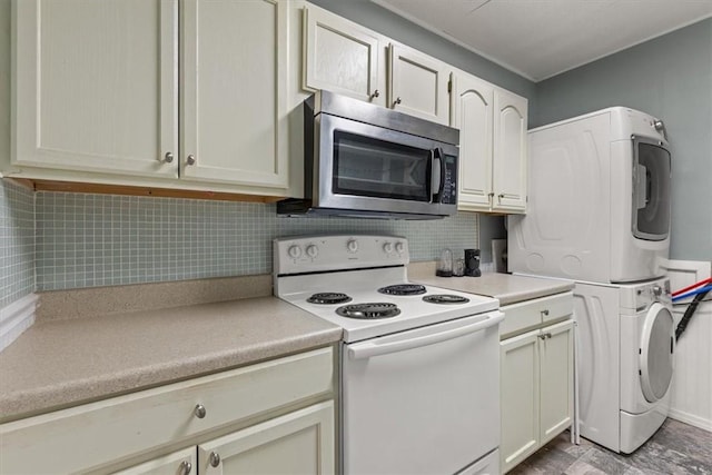5 Sorbie Dr, Bella Vista, AR 72715 - kitchen with white electric range, stainless steel microwave, stacked washing machine and dryer, light countertops, and backsplash
