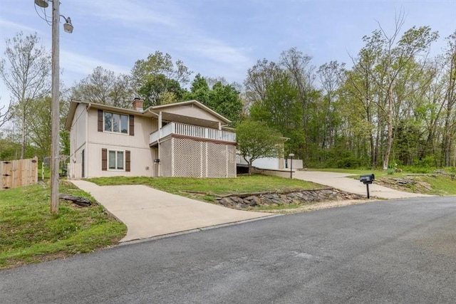 5 Sorbie Dr, Bella Vista, AR 72715 - view of front of property featuring a chimney, driveway, and a balcony