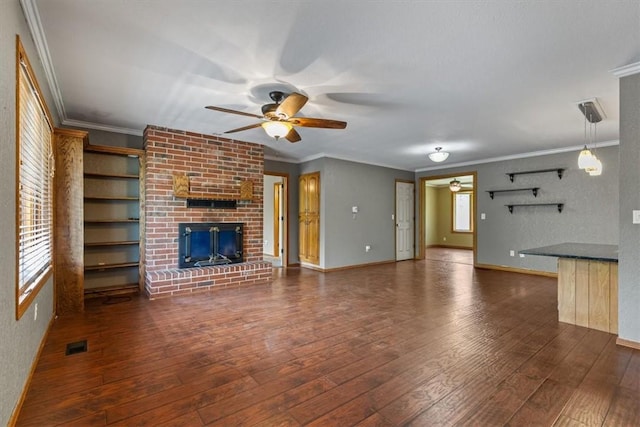 5 Sorbie Dr, Bella Vista, AR 72715 - unfurnished living room with a ceiling fan, a fireplace, dark wood-type flooring, and crown molding