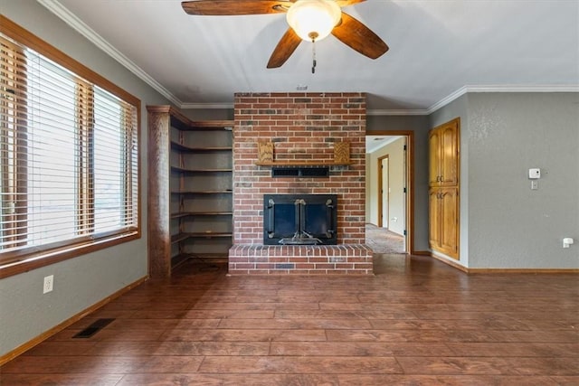 5 Sorbie Dr, Bella Vista, AR 72715 - unfurnished living room with wood-type flooring, healthy amount of natural light, a fireplace, a ceiling fan, and crown molding