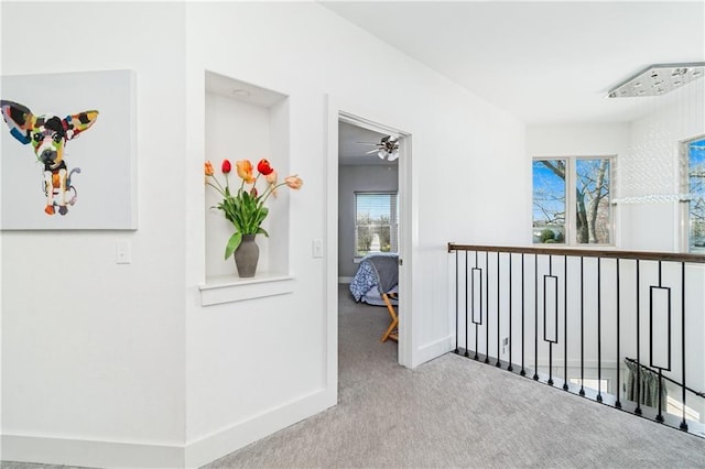 113 SE F St, Bentonville, AR 72712 - corridor featuring baseboards, carpet, and an upstairs landing