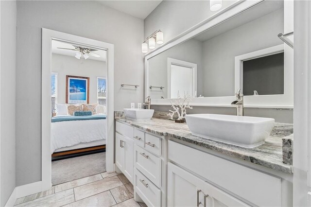 113 SE F St, Bentonville, AR 72712 - bathroom featuring a sink, ceiling fan, ensuite bathroom, and double vanity