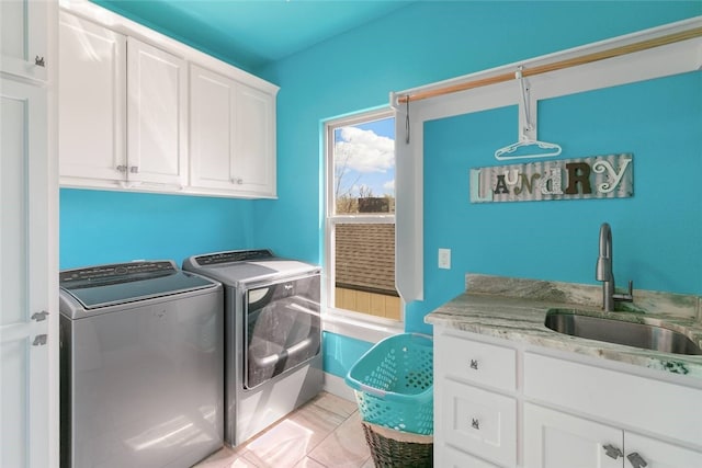 113 SE F St, Bentonville, AR 72712 - laundry room with a sink, washing machine and dryer, and cabinet space