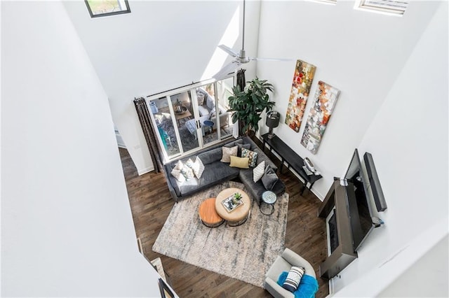 113 SE F St, Bentonville, AR 72712 - living area with visible vents, a ceiling fan, wood finished floors, and a towering ceiling