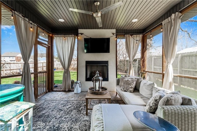 113 SE F St, Bentonville, AR 72712 - sunroom featuring a ceiling fan, an outdoor living space with a fireplace, and wooden ceiling